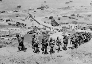 2. US Infantry Division lander ved E1 Easy Red Omaha Beach 7. juni 1944. WN65 ses i baggrunden.