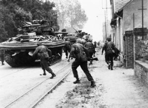 Sherman DD tanks B Squadron 13th18th Royal Hussars support commandos of No 4 Commando 1st Special Service Brigade on the Rue de Riva-Bella Sword area 6 June - IWM-MH-2012