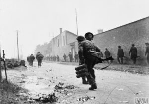 Troops from No 4 Commando 1st Special Service Brigade advance along the Route de Lion towards Ouistreham Sword area 6 June 1944 - IWM-MH-002349